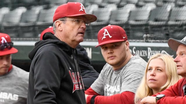 Razorbacks coach Dave Van Horn talking with team between innings